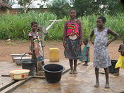 Ewe village carrying water